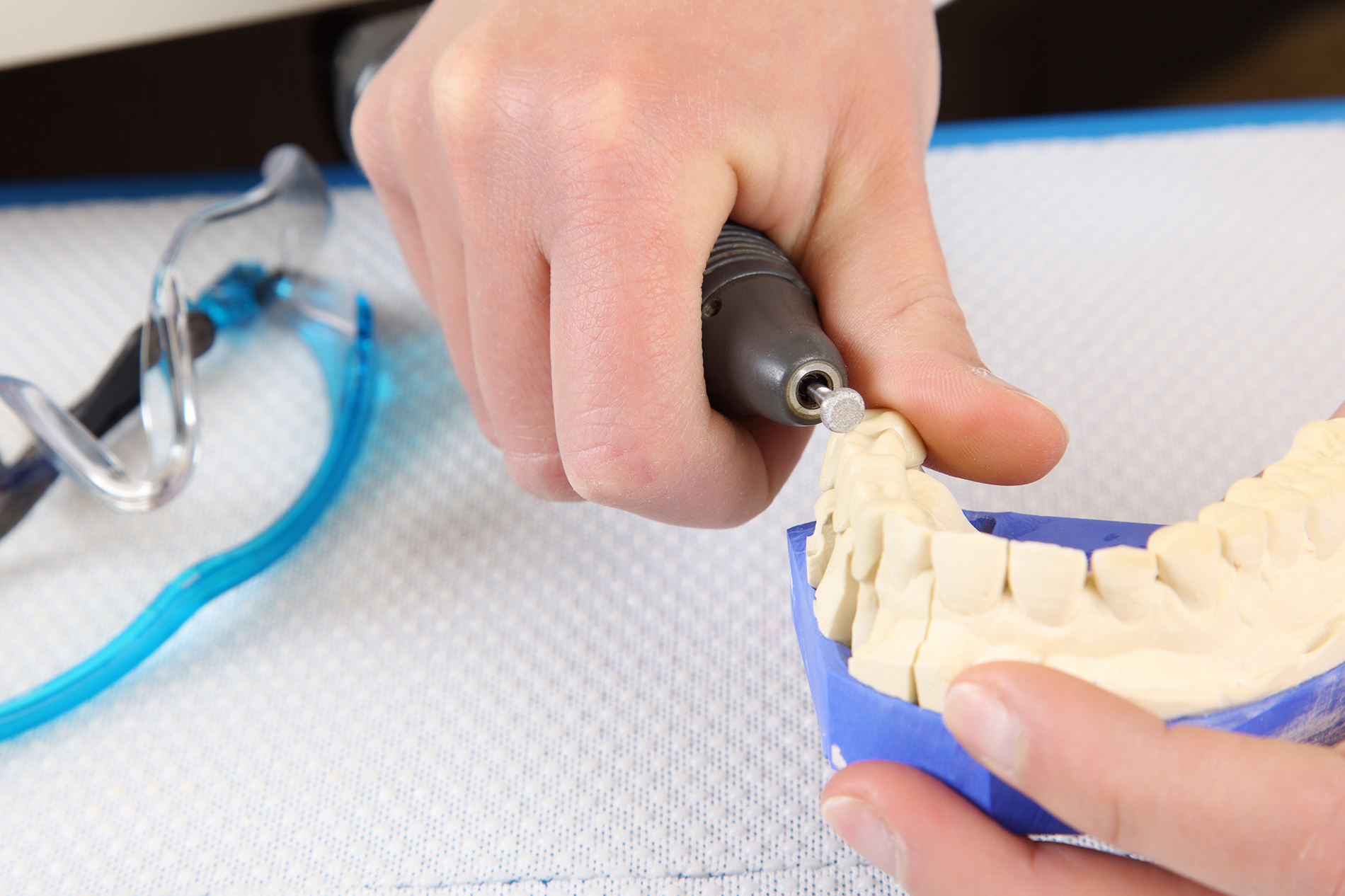 Dental surgeon molding prosthetic teeth Dental surgeon molding prosthetic teeth